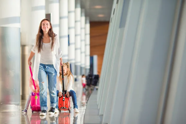 Happy family with two kids in airport have fun waiting for boarding — Stock Photo, Image