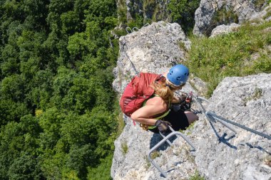 Kadın Romanya 'nın Persani dağlarındaki Varghis vadilerinde bir ferrata' ya tırmanıyor. Yaz etkinlikleri, macera, kopyalama alanı.