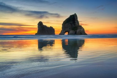 Sunset at  Wharariki Beach, New Zealand clipart