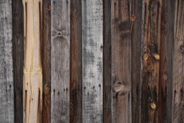 Ahşap desenli duvar kâğıdı arka plan, klasik karartılmış çit. Paslı çivili gri ve kahverengi tahtalar.