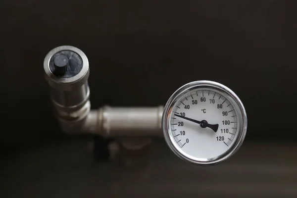 Dispositivo para medir la temperatura del agua en el sistema de calefacción. válvula de alivio de presión de tubería. —  Fotos de Stock