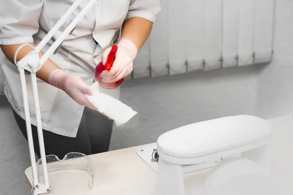 Disinfection of surfaces from viruses and bacteria. Treatment of the table and tools before the procedure in the manicure and pedicure salon. Sterility and cleanliness.