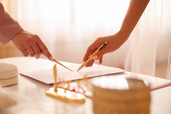 Bride signing marriage certificate, signature wedding contract