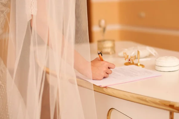 Bride signing marriage certificate, signature wedding contract