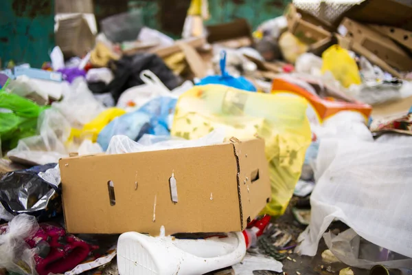 A pile of garbage in a landfill and an abundance of waste, trash and pollution of plastic bottles and bags on the ground, recycling of waste and the danger of toxic environmental poisoning.