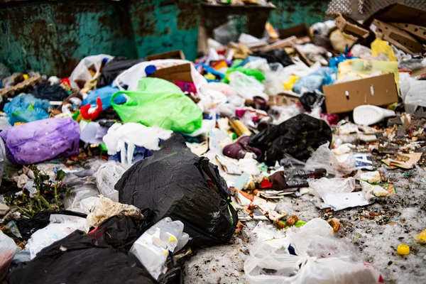 A pile of garbage in a landfill and an abundance of waste, trash and pollution of plastic bottles and bags on the ground, recycling of waste and the danger of toxic environmental poisoning.