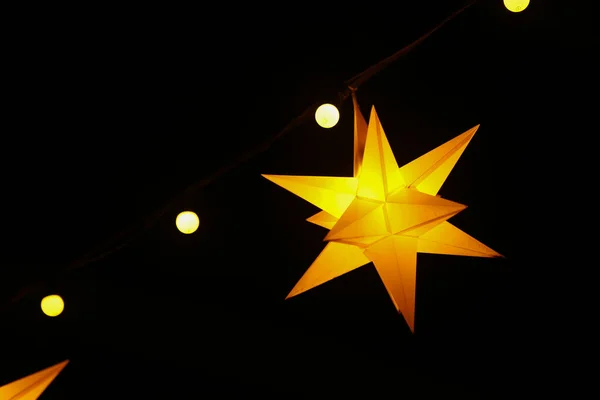 Star paper yellow lantern glows at night close-up — Stock Photo, Image