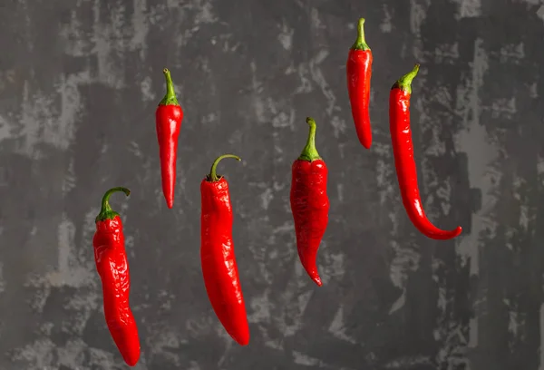 Fresh Chili Peppers Red Color Hang Air Background Decorative Concrete Royalty Free Stock Photos