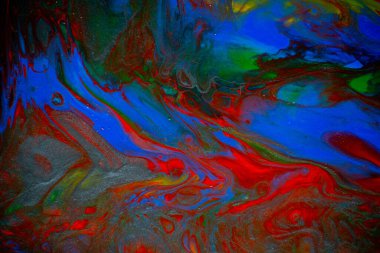 Sıvı sanatının dokusu. Girdap boyası efektli soyut bir arka plan. Sıvı akrilik boya arka planı. Kırmızı, yeşil, sarı ve mavi renkler.
