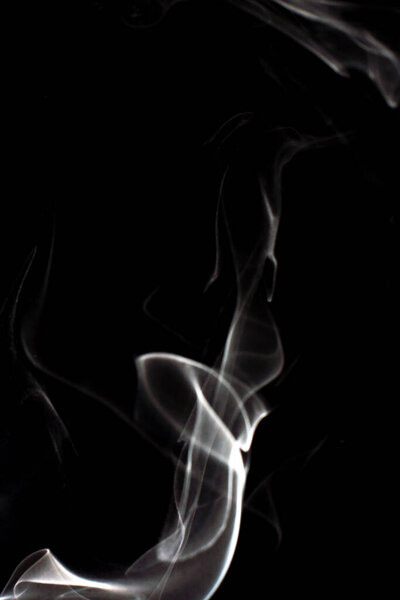 Cloud of white smoke on black background