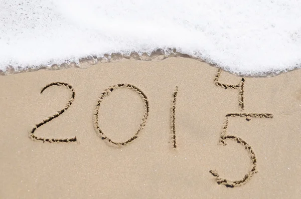 Sign "2014 and 2015" on the beach Royalty Free Stock Photos