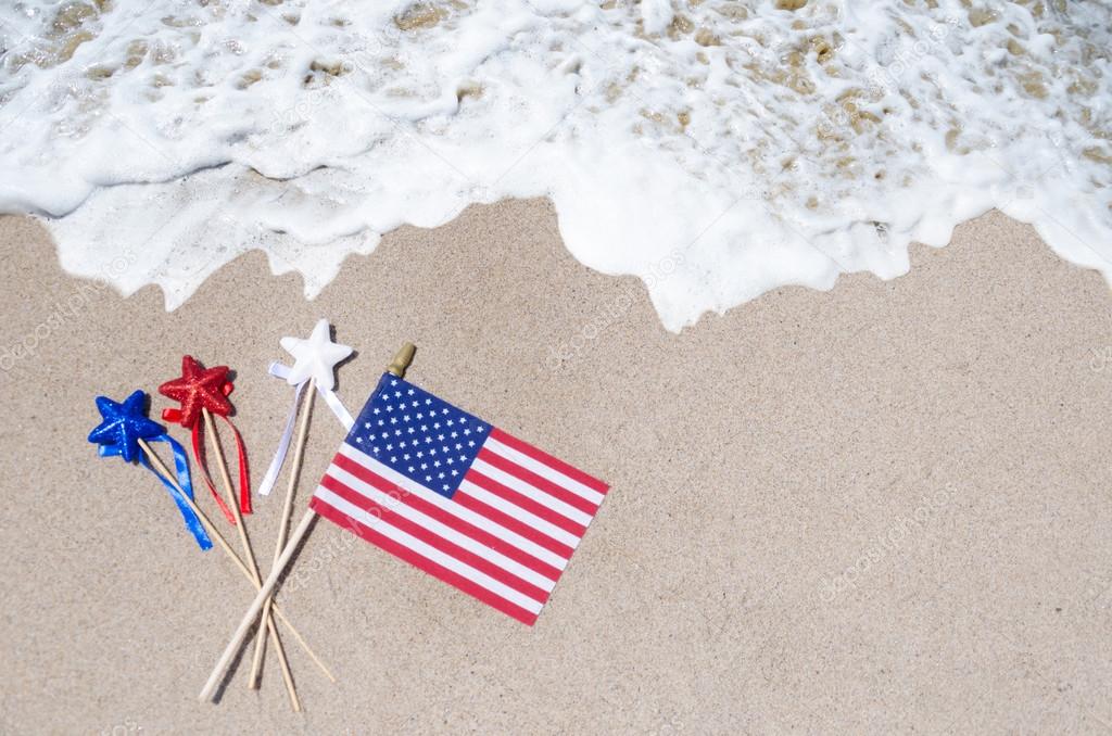 American flag with stars on the sandy beach