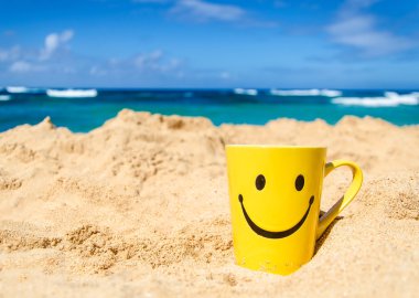 Happy face mug on the beach