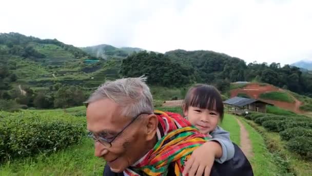 Cute Little Granddaughter Piggyback Ride Her Grandfather Strolling Enjoying Tea — Stock Video