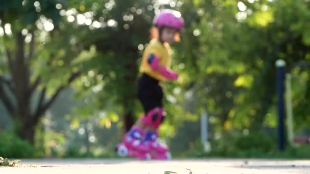 Kleines Mädchen Mit Schutzpolstern Und Schutzhelm Lernt Sommerpark Rollschuhlaufen Aktiver — Stockvideo
