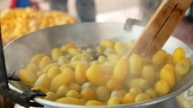 Çiğ ipek iplikleri rulo içine çekmek için sıcak suda kaynayan kozalara yakın çekim. İpek ipliğini ipliklemek için geleneksel yöntem.