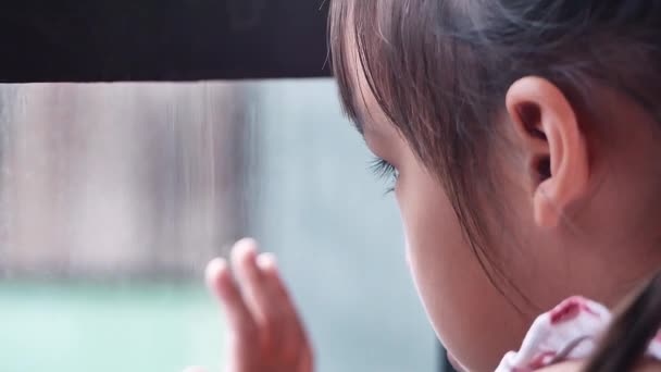 Trauriges Asiatisches Kleines Mädchen Schaut Aus Dem Fenster Den Regnerischen — Stockvideo