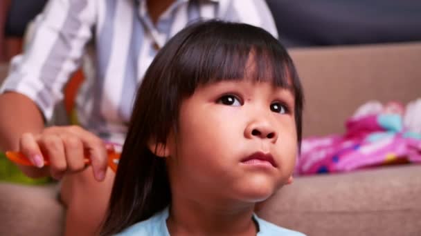 Tutup Menarik Gadis Kecil Sedang Melihat Sementara Ibunya Menyisir Rambut — Stok Video
