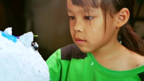 Mała Dziewczynka Maluje Pędzlem Figurze Białego Świńskiego Papierowego Macha Domu — Wideo stockowe