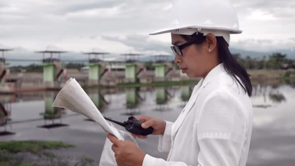 Γυναίκα Μηχανικός Ένα Λευκό Κράνος Χρησιμοποιώντας Ραδιοεπικοινωνία Τον Εργαζόμενο Στο — Αρχείο Βίντεο