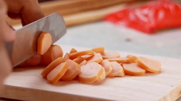 Close Knife Cuts Sausage Small Pieces Mother Holds Her Daughter — Stock Video