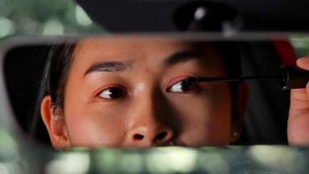 Beautiful Woman Paints Eyelashes While Looking Car Rearview Mirror Parking — Stock Video