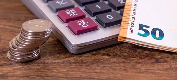 Fifty euros close up and calculator on retro background