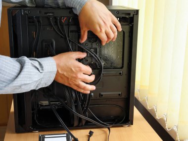 Yeni bilgisayar monte ediliyor, parçalar ayarlanıyor ve sistem ünitesi konutuna kablolar yerleştiriliyor