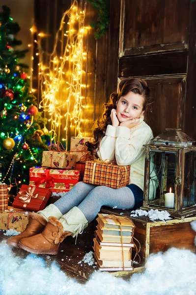 Happy girl near christmas tree Stock Image