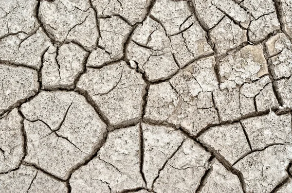 Textura agrietada, seca la superficie de la tierra . — Foto de Stock