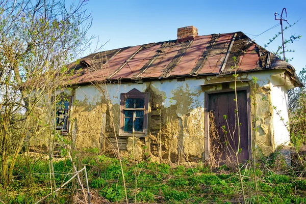Old, ruined, wattle and daub house with broken Windows — стоковое фото