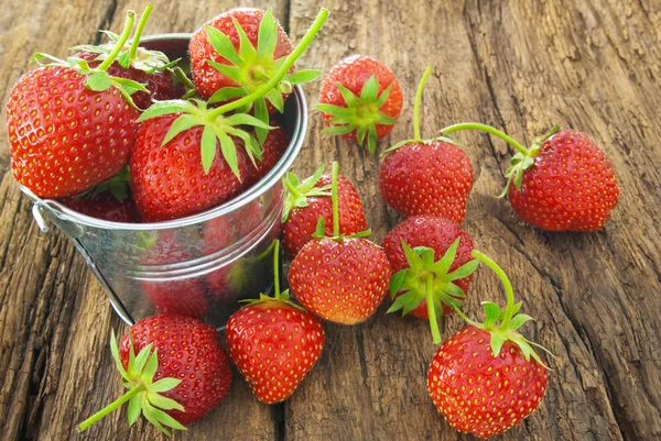 Fresas rojas maduras sobre fondo de madera . — Foto de Stock