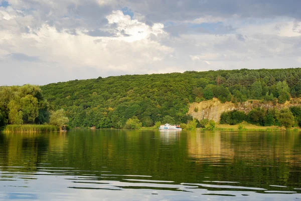 White boat floating down the river on a forest background. — Stock Photo, Image