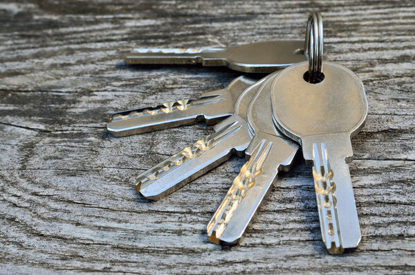 Bunch of keys on a wooden background, close-up