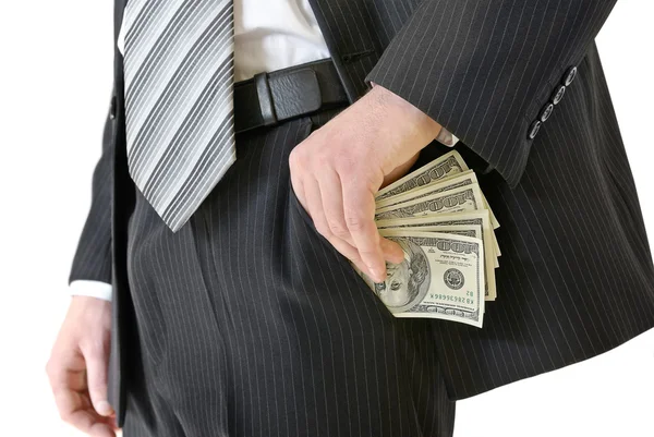 Homem em um terno de negócios colocar dinheiro no seu bolso — Fotografia de Stock