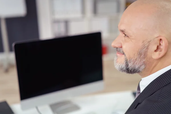 Confident Mature Businessman at Computer Desk — Stok fotoğraf