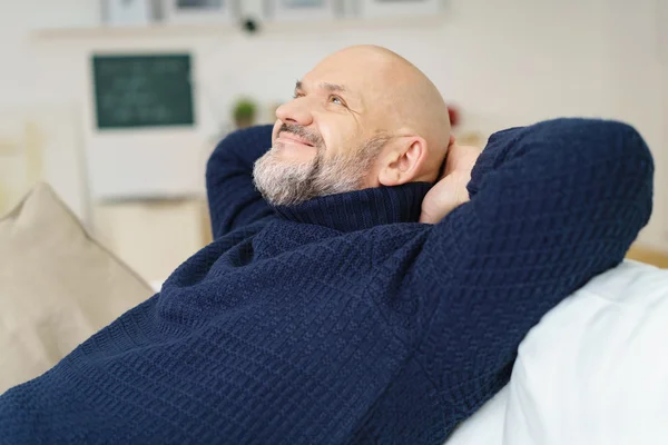 Happy contented man relaxing at home — Stockfoto