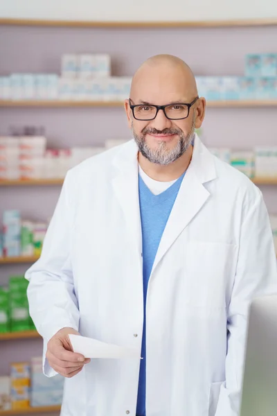 Male pharmacist holding a prescription — Stock Photo, Image