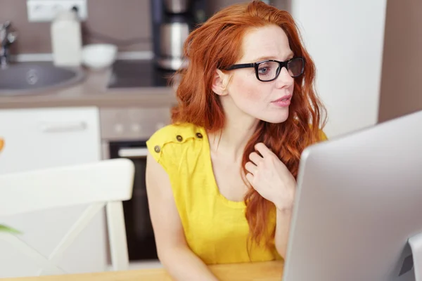 Serious young woman working on a computer