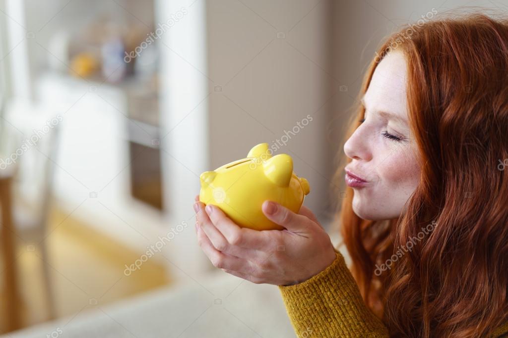 Young Woman Kissing Her Piggy Bank Stock Photo By ©racorn 101486800