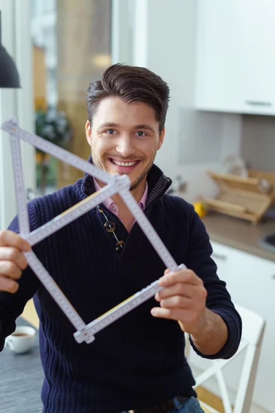 Handsome young man planning for a new home — Stock Photo, Image