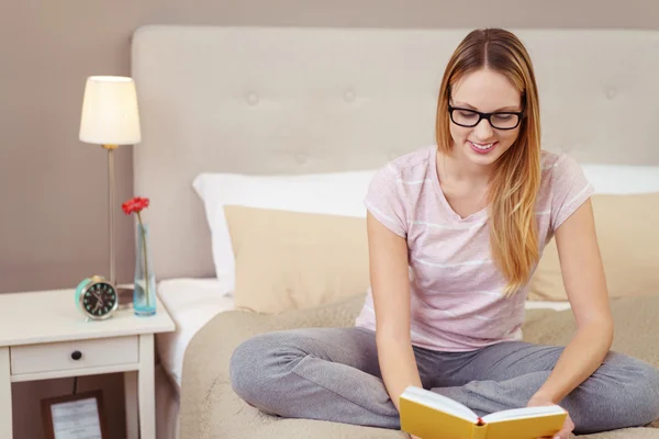 Felice giovane donna godendo la lettura di un libro — Foto Stock