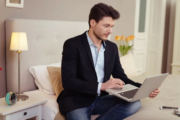 Stijlvolle zakenman met behulp van een laptop tijdens het reizen — Stockfoto