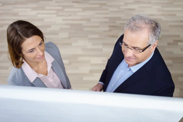 High angle view of two executives at chart — Stock Photo, Image