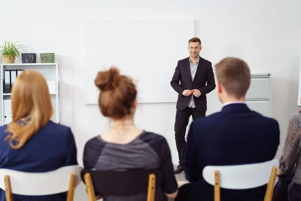 Cheerful man at white board during staff meeting — Stock Photo, Image