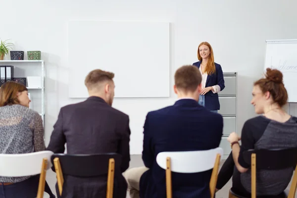 Enthusiastic woman at white board during meeting — Stock Photo, Image