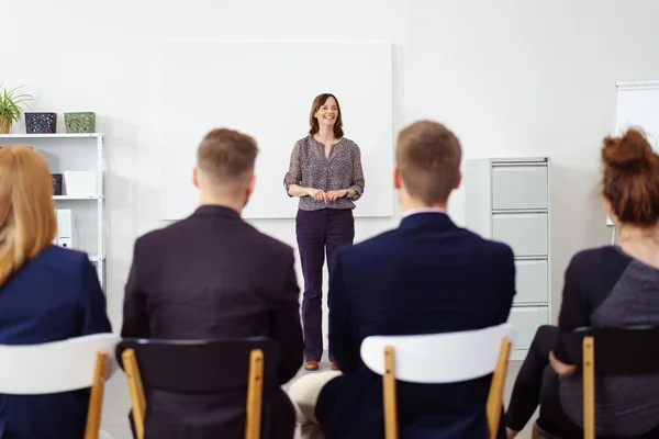 Smiling businesswoman giving a presentation — Stock Photo, Image