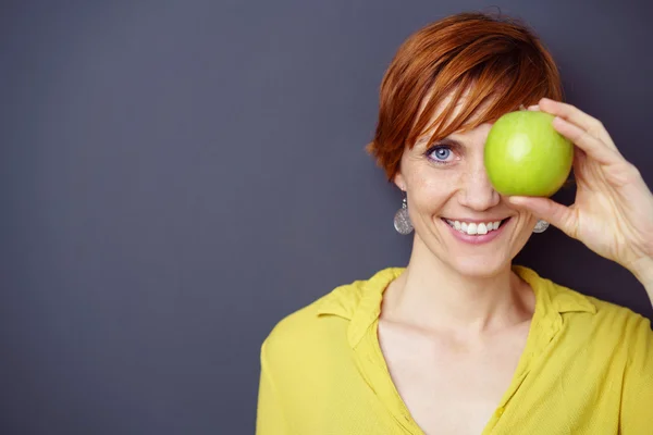 Happy smiling woman covering her one eye — Stock Photo, Image