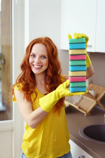 Beautiful cleaning woman with stack of sponges — Stock Photo, Image