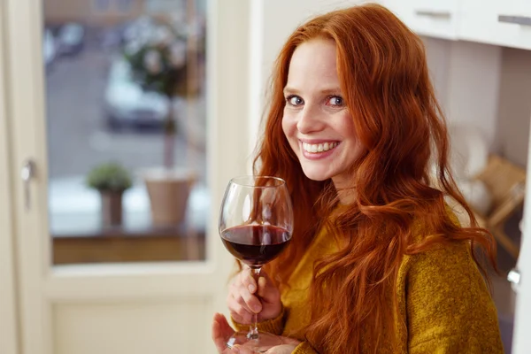 Happy woman holding glass of wine — Stock Photo, Image